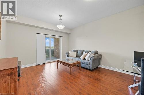 Living room with dark wood-style floors, an office area, and a textured ceiling - 8111 Forest Glen Drive Unit# 524, Niagara Falls, ON - Indoor Photo Showing Other Room