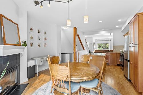 124-456 Mcphee Street, Kelowna, BC - Indoor Photo Showing Dining Room With Fireplace