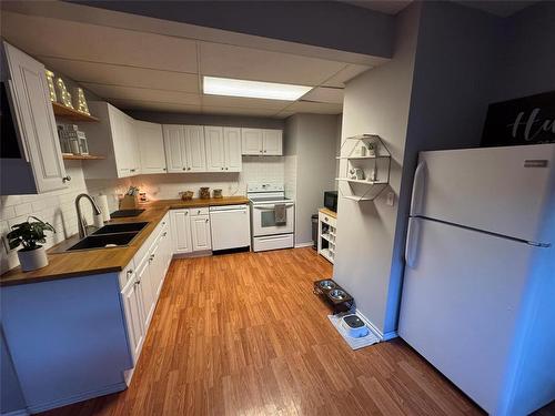 145 1St Street, Brandon, MB - Indoor Photo Showing Kitchen With Double Sink