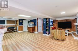 Expansive basement living areas with wood flooring - 