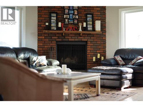 Functional Wood Fireplace - 5826 Bartlett Road, Vernon, BC - Indoor Photo Showing Living Room With Fireplace