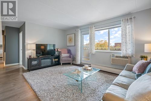 Large living room with door to terrace - 421 - 198 Scott Street, St. Catharines (Fairview), ON - Indoor Photo Showing Living Room