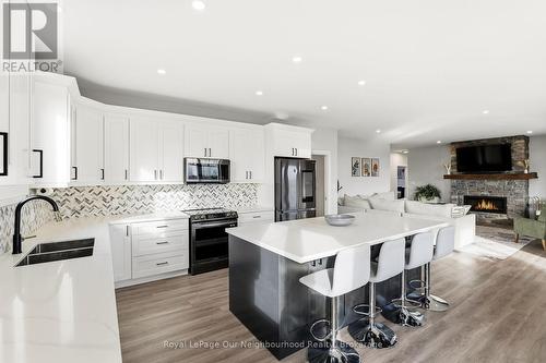 14321 County Road 2, Cramahe, ON - Indoor Photo Showing Kitchen With Fireplace With Double Sink With Upgraded Kitchen