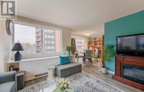 303 - 20 Ellen Street E, Kitchener, ON - Indoor Photo Showing Living Room With Fireplace