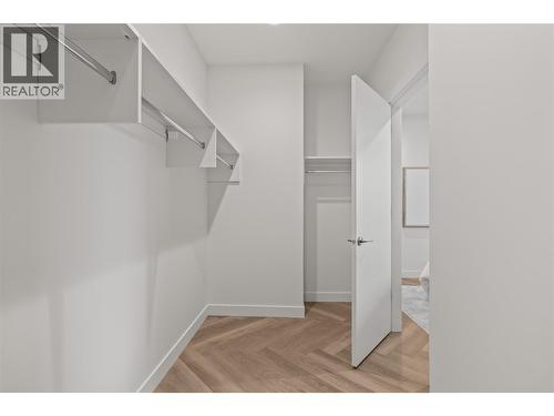 Primary Bedroom Walk-Through Closet - 3340 Lakeshore Road Unit# 902, Kelowna, BC - Indoor With Storage