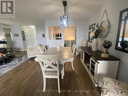 Dining area featuring dark wood finished floors - 