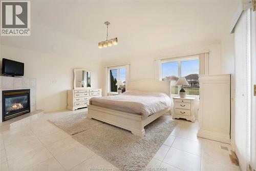 1075 Stoneybrook, Windsor, ON - Indoor Photo Showing Bedroom With Fireplace