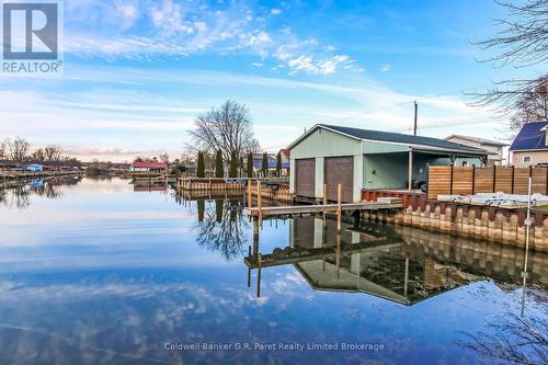 Double boat house. - 1 Duncan Street, Norfolk (Turkey Point), ON - Outdoor With Body Of Water With Deck Patio Veranda