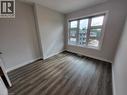 Unfurnished room with baseboards and dark wood-style floors - 118 Gravel Ridge Trail Unit# A8, Kitchener, ON  - Indoor Photo Showing Other Room 