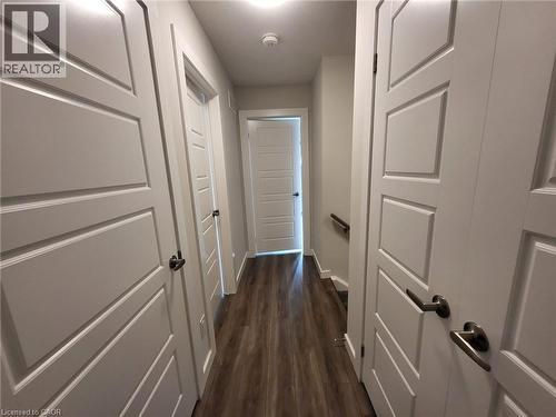 Hallway with dark wood-type flooring and baseboards - 118 Gravel Ridge Trail Unit# A8, Kitchener, ON - Indoor Photo Showing Other Room