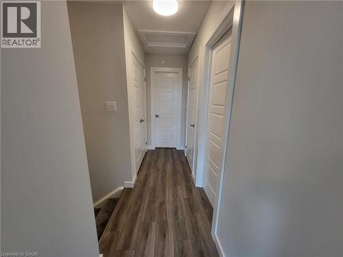 Corridor with dark wood-type flooring and attic access - 118 Gravel Ridge Trail Unit# A8, Kitchener, ON - Indoor Photo Showing Other Room