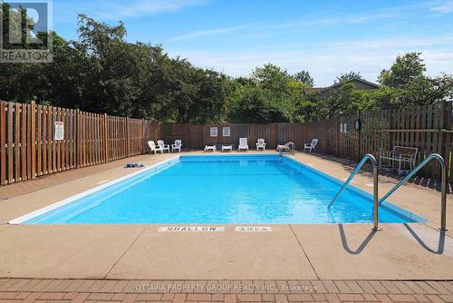 416 - 555 Brittany Drive, Ottawa, ON - Outdoor With In Ground Pool With Backyard