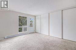 Wall of closet space in primary bedroom - 