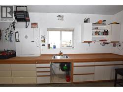 There is s sink and a work bench in the garage - 