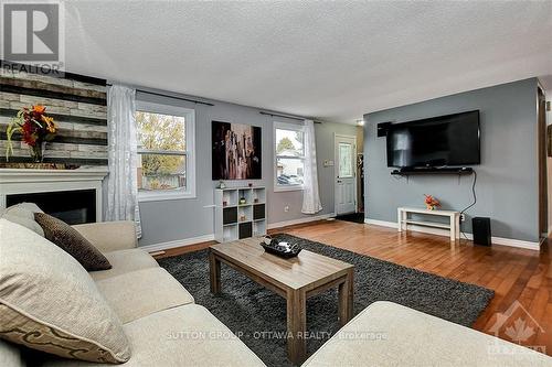 20 Dundegan Drive, Ottawa, ON - Indoor Photo Showing Living Room With Fireplace