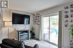 Den has a walkout to a 2-level deck with hot tub. - 