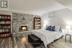 Bedroom includes a brick fireplace with gas insert - 