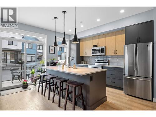 Open Concept  Kitchen with Island seating - main floor - 1435 Cara Glen Court Unit# 119, Kelowna, BC - Indoor Photo Showing Kitchen With Stainless Steel Kitchen With Upgraded Kitchen