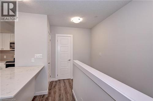 Corridor featuring dark wood-style floors and a textured ceiling - 118 Gravel Ridge Trail Unit# C17, Kitchener, ON - Indoor Photo Showing Other Room
