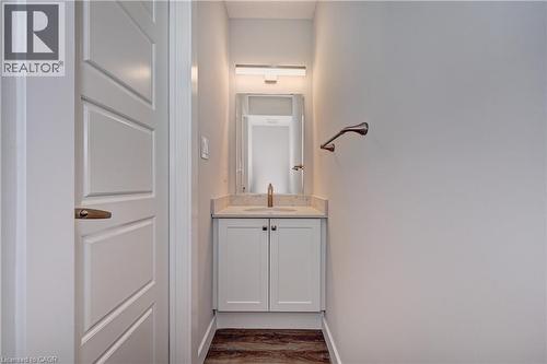 Half bathroom with vanity and dark wood-style flooring - 118 Gravel Ridge Trail Unit# C17, Kitchener, ON - Indoor