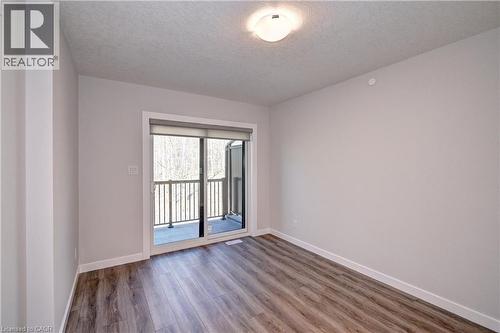 Spare room featuring wood finished floors and a textured ceiling - 118 Gravel Ridge Trail Unit# C17, Kitchener, ON - Indoor Photo Showing Other Room