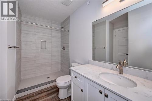 Full bathroom with a shower stall, vanity, and dark wood-type flooring - 118 Gravel Ridge Trail Unit# C17, Kitchener, ON - Indoor Photo Showing Bathroom