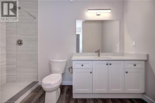Full bathroom featuring a shower stall, vanity, and dark wood-type flooring - 118 Gravel Ridge Trail Unit# C17, Kitchener, ON - Indoor Photo Showing Bathroom