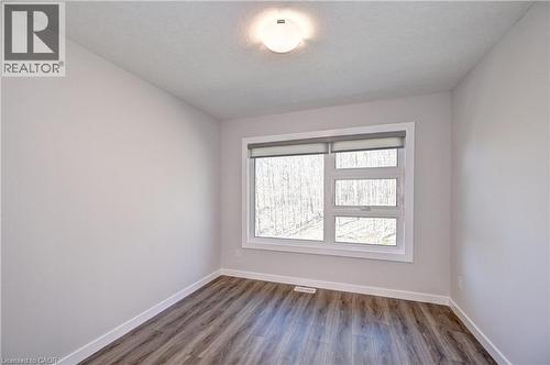 Empty room featuring baseboards and wood finished floors - 118 Gravel Ridge Trail Unit# C17, Kitchener, ON - Indoor Photo Showing Other Room