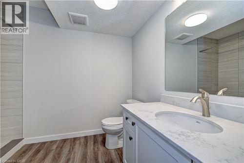 Full bathroom with tiled shower, vanity, light wood finished floors, and a textured ceiling - 118 Gravel Ridge Trail Unit# C4, Kitchener, ON - Indoor Photo Showing Bathroom
