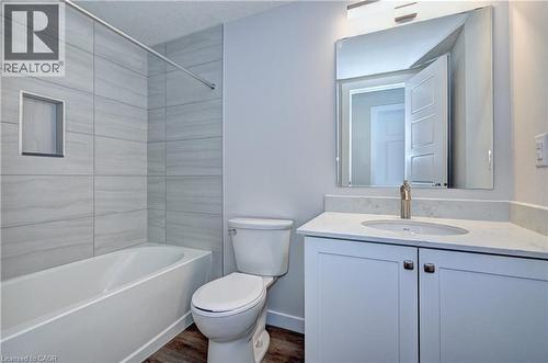 Full bath featuring vanity, shower / washtub combination, and dark wood finished floors - 118 Gravel Ridge Trail Unit# C4, Kitchener, ON - Indoor Photo Showing Bathroom