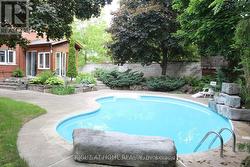 View of pool in summer. - 