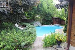 View from side of home across pool to South-East. - 