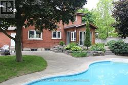 View of home from inground salt-water pool. - 