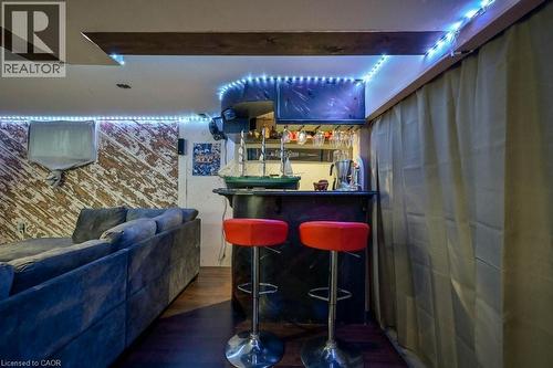 Indoor dry bar with dark wood-style flooring - 131 Elmwood Avenue, Cambridge, ON - Indoor Photo Showing Other Room