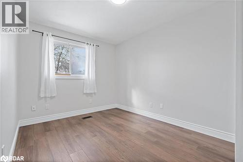 Unfurnished room featuring hardwood / wood-style flooring and baseboards - 16 Bush Street, Collingwood, ON - Indoor Photo Showing Other Room