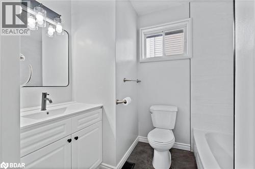 Bathroom featuring vanity and dark tile patterned floors - 16 Bush Street, Collingwood, ON - Indoor Photo Showing Bathroom