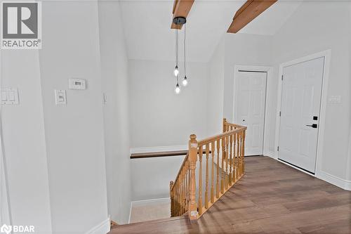Hallway with an upstairs landing, dark wood finished floors, and lofted ceiling - 16 Bush Street, Collingwood, ON - Indoor Photo Showing Other Room