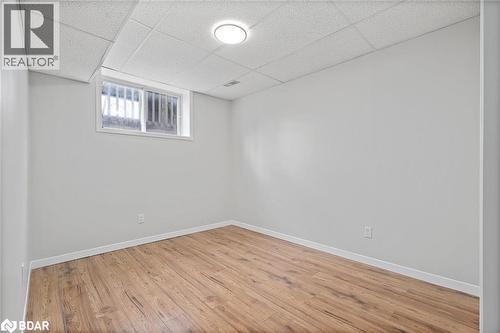 Below grade area featuring a paneled ceiling and wood finished floors - 16 Bush Street, Collingwood, ON - Indoor Photo Showing Other Room