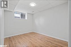 Below grade area featuring a paneled ceiling and wood finished floors - 