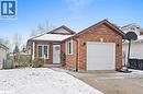 View of front of house with brick siding, concrete driveway, and an attached garage - 16 Bush Street, Collingwood, ON  - Outdoor 