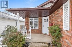 Entrance to property with brick siding and a porch - 