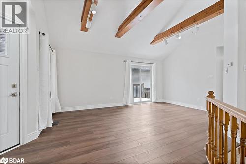 Spare room with beam ceiling, hardwood / wood-style floors, and high vaulted ceiling - 16 Bush Street, Collingwood, ON - Indoor Photo Showing Other Room