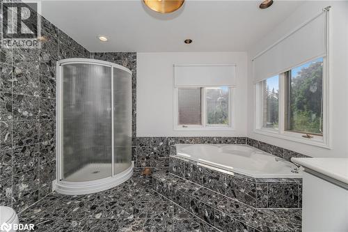Full bathroom featuring a bath, a stall shower, tile walls, and recessed lighting - 100 National Drive, Hamilton, ON - Indoor Photo Showing Bathroom