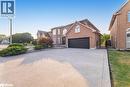 Traditional-style home with a gate, concrete driveway, brick siding, and a garage - 100 National Drive, Hamilton, ON  - Outdoor 