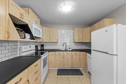 109-4-7841 Highway 97 N, Kelowna, BC - Indoor Photo Showing Kitchen With Double Sink
