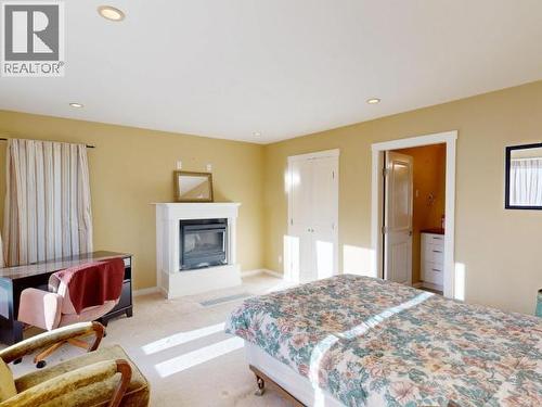 3004 Pebble Beach Road, Powell River, BC - Indoor Photo Showing Bedroom With Fireplace