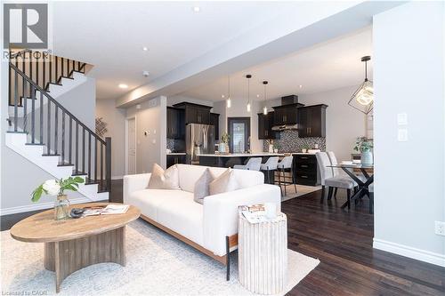 Living area with stairway, dark wood-style floors, and recessed lighting - 709 Rock Elm Street, Waterloo, ON - Indoor Photo Showing Living Room