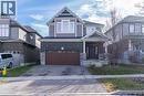 View of front of property with asphalt driveway, a garage, and brick siding - 709 Rock Elm Street, Waterloo, ON  - Outdoor With Facade 