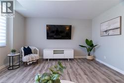 Living area featuring wood finished floors and a textured ceiling - 