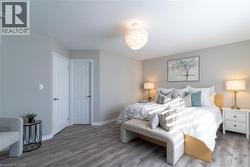 Bedroom with wood finished floors and a textured ceiling - 